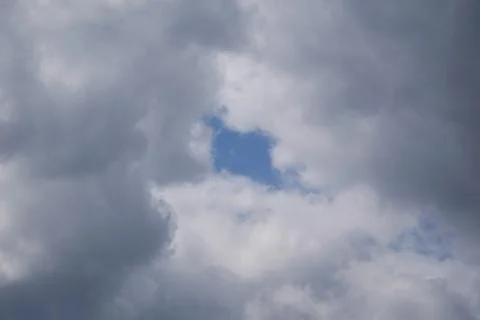 Window into the sky among clouds. Stock Photos