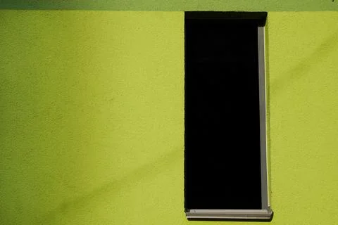 Window with space for text on green plastered built wall 库存照片
