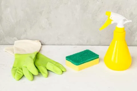 Window spray, sponge and gloves on gray background, spring cleaning concept.  Stock Photos