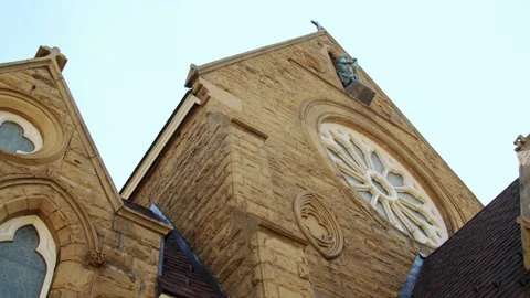 Window, statue, and cross on historic church in Muskegon, Michigan. 4k60p Stock Footage 132921583