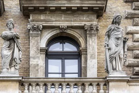 Window with statues. Stock Photos