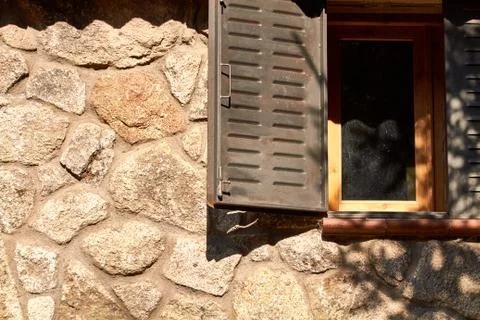 Window on a stone cabin Stock Photos