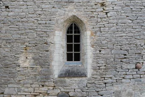 Window in the stone wall of an ancient monastery destroyed during the Livonian W Stock Photos
