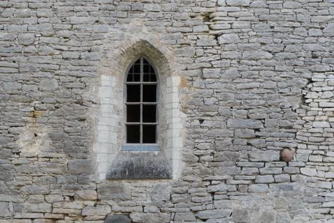 Window in the stone wall of an ancient monastery destroyed during the Livonian W Stock Photos