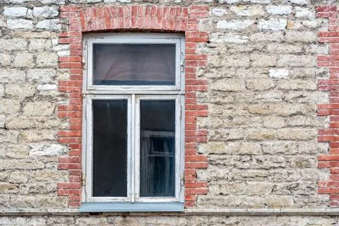 Window on the stone wall. Stock Photos