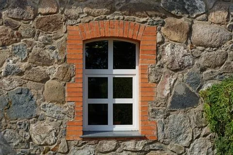 Window on a stone wall. Stock Photos
