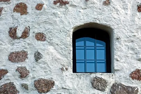 Window on a stone wall. Stock Photos