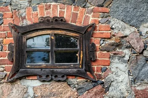 Window on a stone wall. Stock Photos