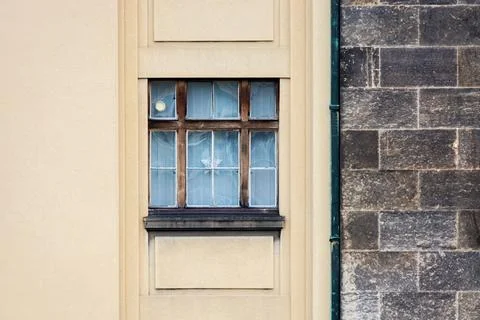 Window on a stone wall. Stock Photos