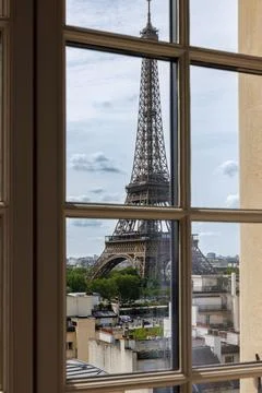 Window with a stunning view of the iconic Eiffel Tower in Paris, France Stock Photos