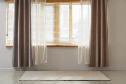 Window with stylish grey and white curtains in empty room Stock Photos