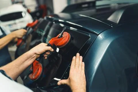 Window suction cups as necessity in windshield and rear window repair kit. Hands Stock Photos