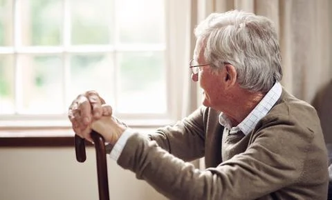 Window, thinking and old man with cane in home, retirement and good memorie.. Stock Photos