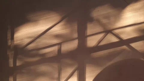 Window trellis shadow on white wall at sunset Stock Footage 312855058