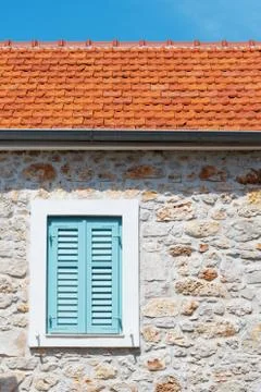 Window with turquoise window blinds on an old mediterranean house Stock Photos
