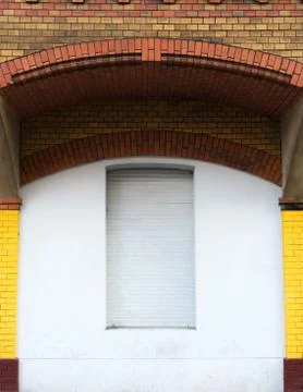The window under the brick arch is closed Stock Photos
