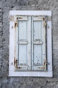 Window with unpainted shutters Stock Photos