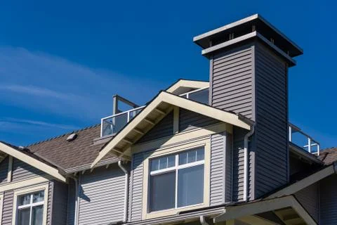 Window on upper level of residential building with patio on the roof Stock Photos