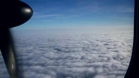 Window View of airplane. Airplane flies above the clouds Stock Footage 75329596