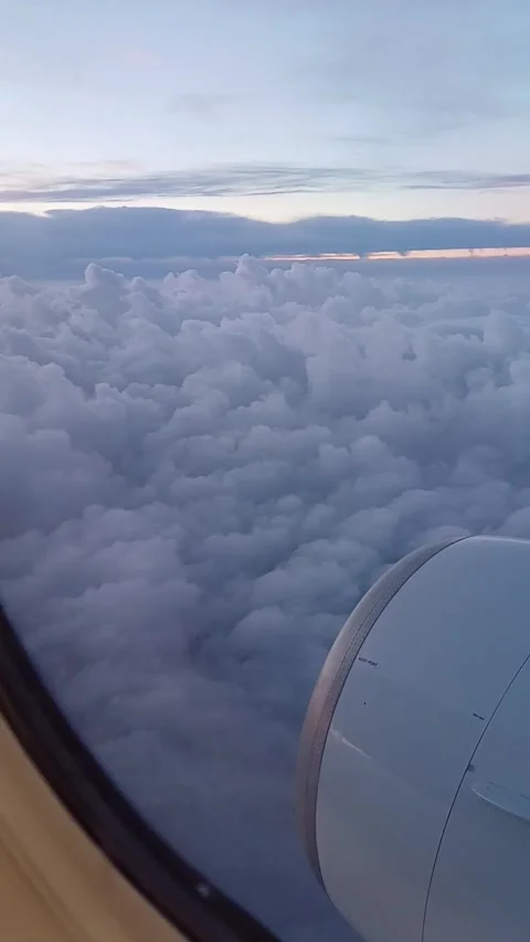 Window view of an airplane engine flying high above clouds, perfect for video Stock Footage 281928801