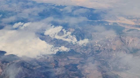 Window View From An Airplane Looking At California with clouds over the mountain Video stock 320091330