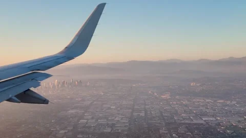 Window View From An Airplane Looking At Los Angeles City During Sunset Stock Footage 317876009