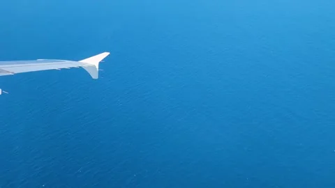 Window View From An Airplane Looking Pacififc Ocean as Airplane makes a turn Video stock 320091324
