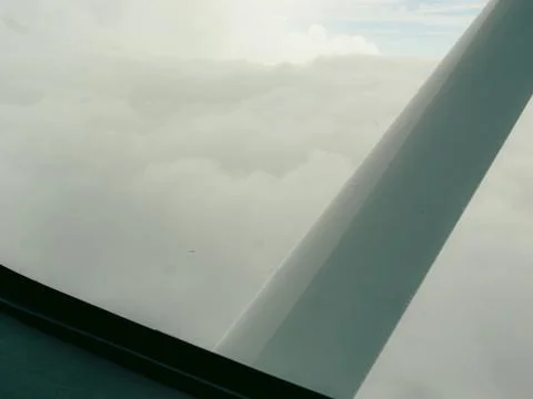 Window view captures light aircraft wing Stock Photos