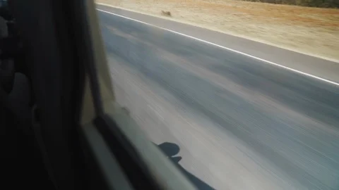 Window View of Car Driving Down a Road Stock Footage 123868687