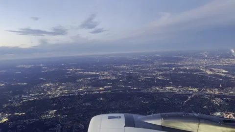 Window view of city lights and a big jet engine placidly rolling by Stock Footage 264069582