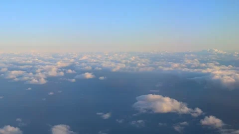 Window view of cloudy sky at sunset. Flying at cloud level Stock Footage 258573877
