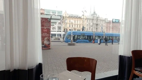 Window view of Downtown Zagreb Cafe with tram in background Stock Footage 127296196
