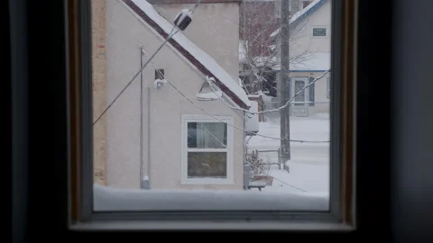 Window view of falling snow by residential house in winter Stock Footage 295910913