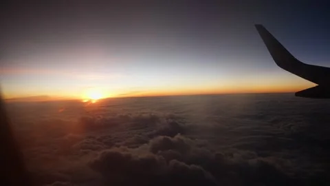 Window view of flying airplane sunset scene Stock Footage 325173769