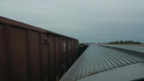 A Window View of a Freight Train passing the Canadian Passenger Train Stock Footage 92652329