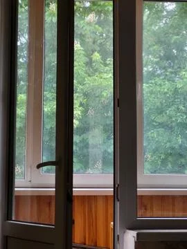 Window view of green trees from inside Stock Photos