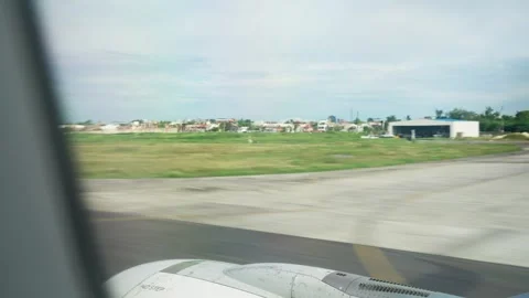 Window view of inside flying airplane taking off Stock Footage 325173807