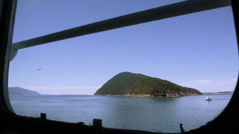Window view of an island and boat. Stock Footage 70337402