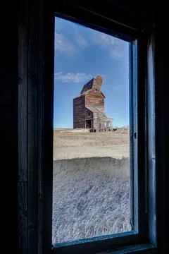 A window with a view of a large, old building Stock Photos