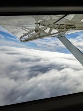 Window view from light general aviation aircraft. Strut and wing of semi-ca.. Stock Photos