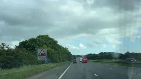 Window View of Motorways and Traffic During Car Travel From Scotland to England Stock Footage 314469296