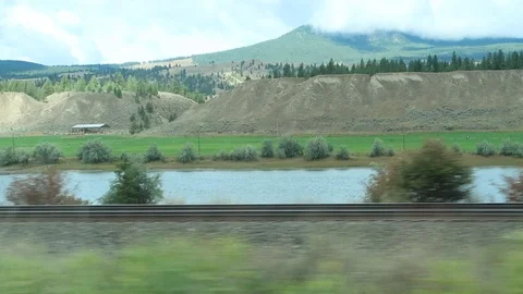 Window View of the Mountains and Lake while in a Car Stock Footage