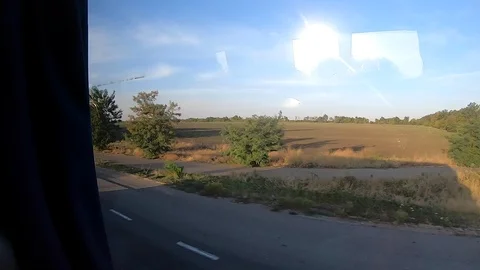 Window view of moving bus. Bus shadow on highway. View from high speed Stock Footage 121520907