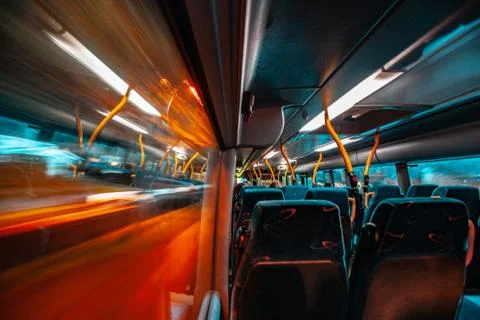 Window view of a moving bus at night city. Blurry lights of lanterns. Foto stock