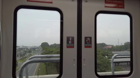Window View of Moving Skytrain, Riding Soekarno Hatta Airport Skytrain Stock Footage 129910146