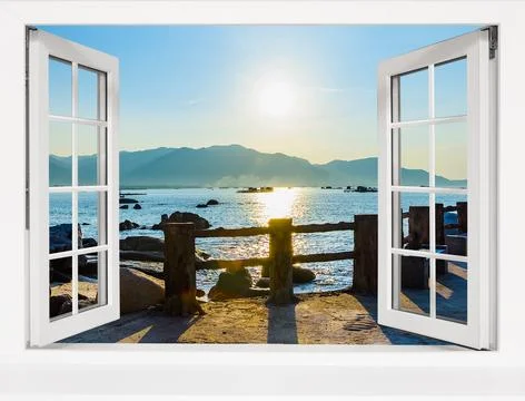Window with a view of the ocean and mountains Photos