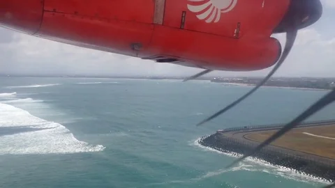 Window view of plane propeller as it reverses direction flying into Bali airport Stock Footage 85304072