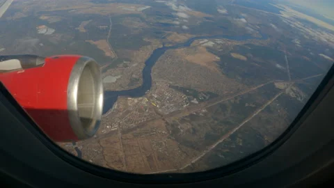 Window view from plane. Wing and turbine of aircraft. Landscape with a river Stock Footage 193998092