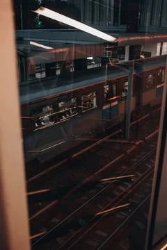 Window view of the railroad station platform and the passing train Fotos Stock