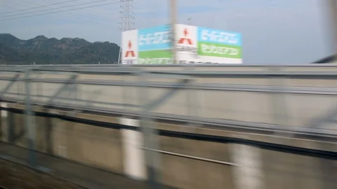 Window view of Shinkansen passing by another train before entering tunnel Stock-Footage 113383058